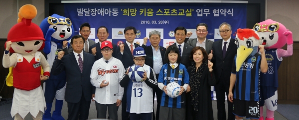 28일 ‘발달장애 아동 희망 키움 스포츠 교실’ 협약 체결 후, SK인천석유화학 최남규 사장(뒷줄 좌측에서 4번째, 구단 마스코트 제외)을 비롯한 9개 기관 대표, 스포츠 교실에 참여하는 학생들이 함께 기념촬영을 하고 있다.ㅣ사진=SK인천석유화학