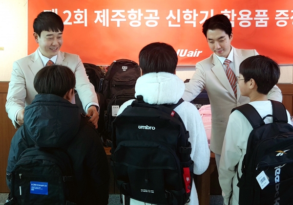 지난 2월7일 제주항공 객실승무원들이 제주보육원 어린이들에게 새학기 준비물을 전달하고 있다 [사진=제주항공]