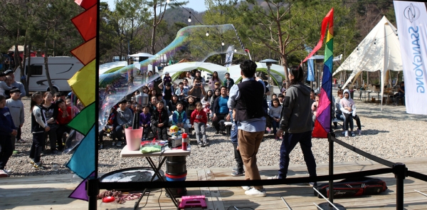 쌍용자동차 고객들이 지난 주말(13~14일) 만개한 봄꽃들로 화사한 충북 제천시 소재 쌍용어드벤처 오토캠핑빌리지(Ssangyong Adventure Auto Camping Village)에서 다양한 가족 단위 체험과 공연을 즐기며 잊을 수 없는 새봄맞이 쌍용패밀리데이 스위트 어라운드 캠프(Sweet Around Camp)를 함께했다고 15일 밝혔다. 참가자들이 대형비눗방울 공연을 관람하고 있다 [사진=쌍용자동차]