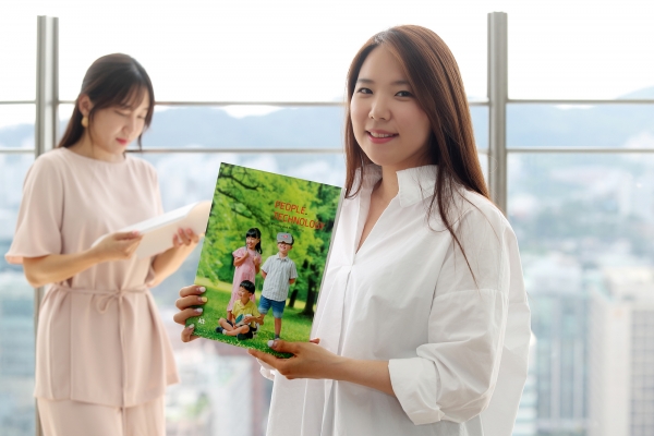 KT 직원들이 '2018 KT 통합보고서'를 보고 있다. (사진=KT)