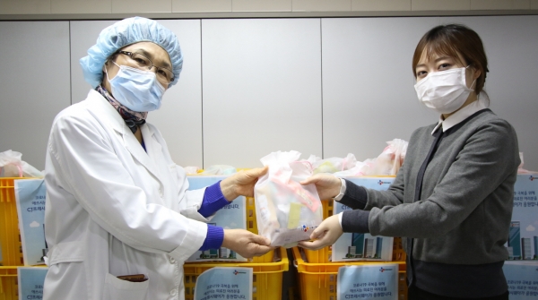 CJ프레시웨이 영양사가 병원 관계자에게 구호물품을 전달하고 있다.